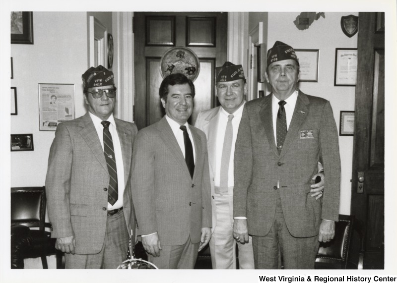 Second from the left, Representative Nick J. Rahall (D-W.Va.) stands for a photograph with three unidentified men of the Veterans of Foreign Wars (VFW).