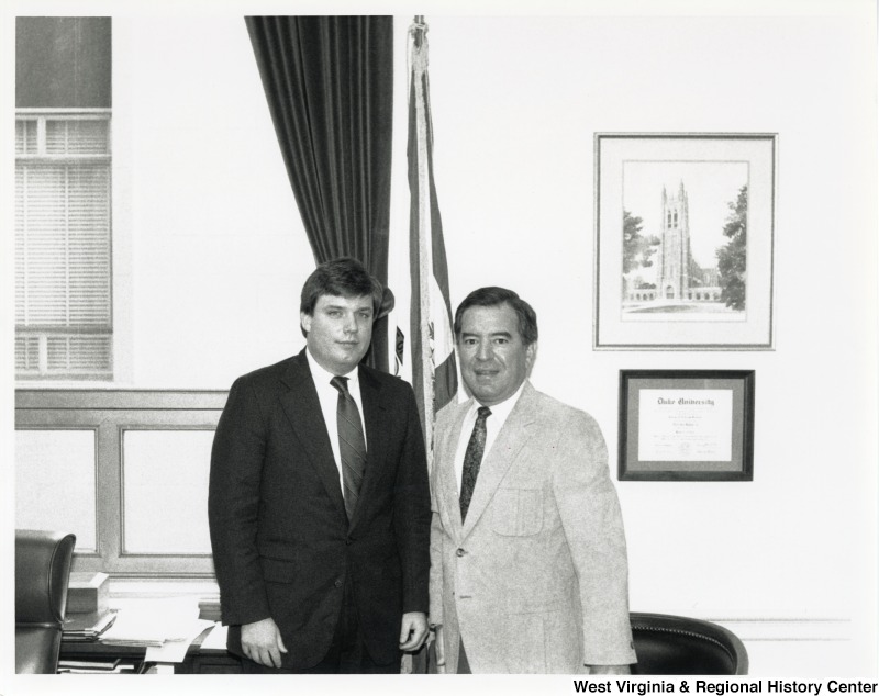On the right, Representative Nick J. Rahall (D-W.Va.) stands for a photograph with an unidentified man.