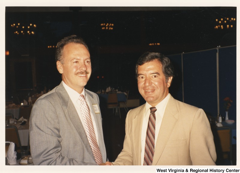 On the right, Representative Nick J. Rahall (D-W.Va.) stands with an unidentified man at an event.