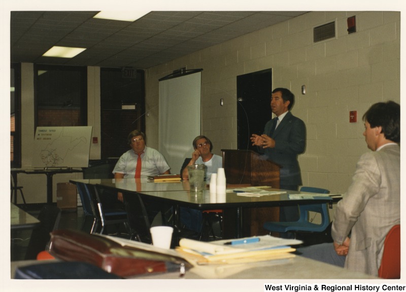 Representative Nick J. Rahall (D-W.Va.) stands behind a podium and gives a speech.