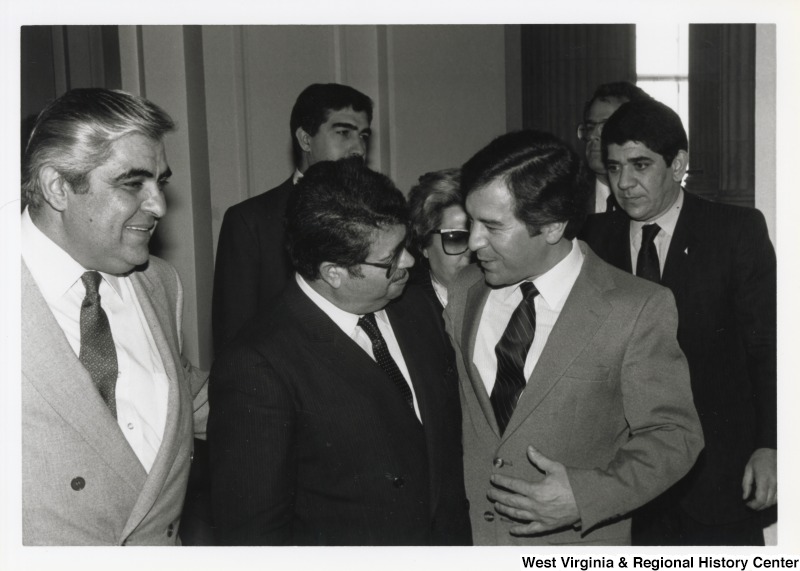 On the right, Representative Nick J. Rahall (D-W.Va.) talks with Turkish Prime Minister Turgut zal in a crowd.