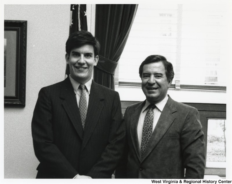 Representative Nick J. Rahall (D-W.Va.) stands to the right of Rick French at a Matewan Officials meeting.