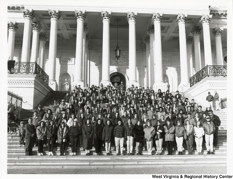 On the far left, Representative Nick J. Rahall (D-W.Va.) stands with a large group of students in front of the Capitol.