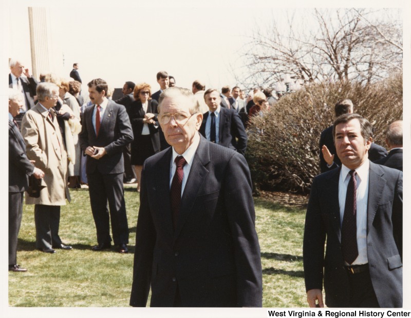 Representative Nick J. Rahall (D-W.Va.) stands among a crowd of unidentified people at Jim Howard's funeral.