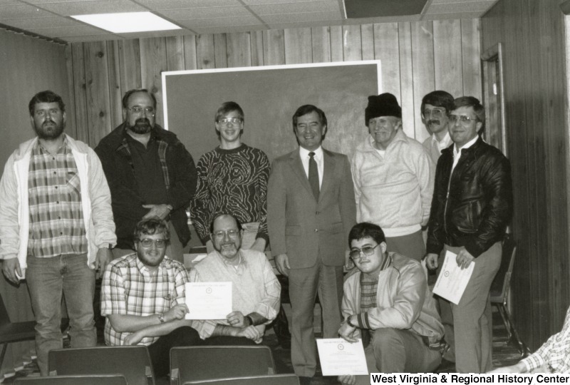 Representative Nick J. Rahall (D-W.Va.) stands in the middle of a group of unidentified men from the Guardian Life Insurance.