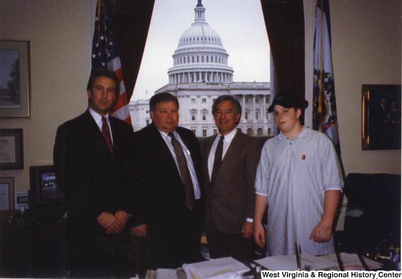 Second from the right, Representative Nick J. Rahall (D-W.Va.) stands with three unidentified men.