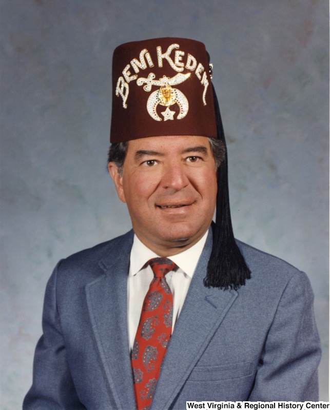 This is a portrait of Representative Nick J. Rahall (D-W.Va.) wearing a fez that reads "Beni Kedem."