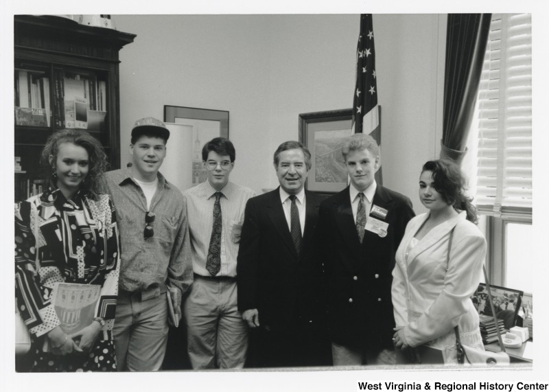 Representative Nick J. Rahall (D-W.Va.) stands for a photograph in the middle of five unidentified people.