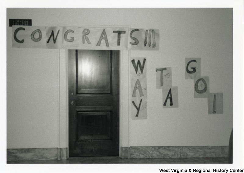 This is a photograph of a door with a banner above and beside it that reads, "Congrats!!! Way Ta Go!"