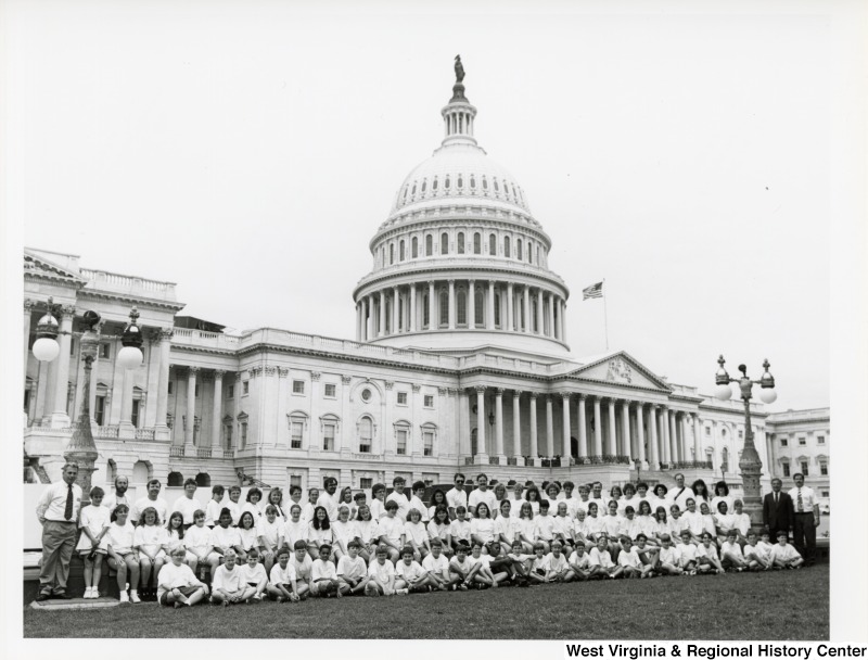 On the far right, Representative Nick J. Rahall (D-W.Va.) stands with an unidentified group of people for a photograph in front of the Capitol building.