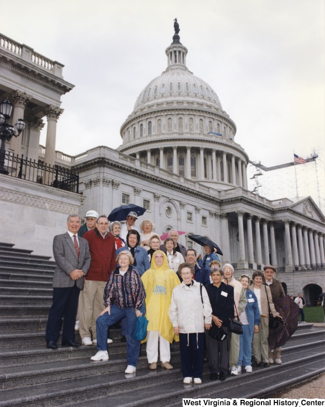 On the far left, Representative Nick J. Rahall (D-W.Va.) stands for a photograph outside the Capitol building with a Sonshiner group from Huntington.