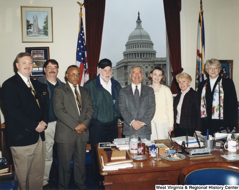 Representative Nick J. Rahall (D-W.Va.) stands for a photograph in his office with a group of seven unidentified people from Logan County, WV.