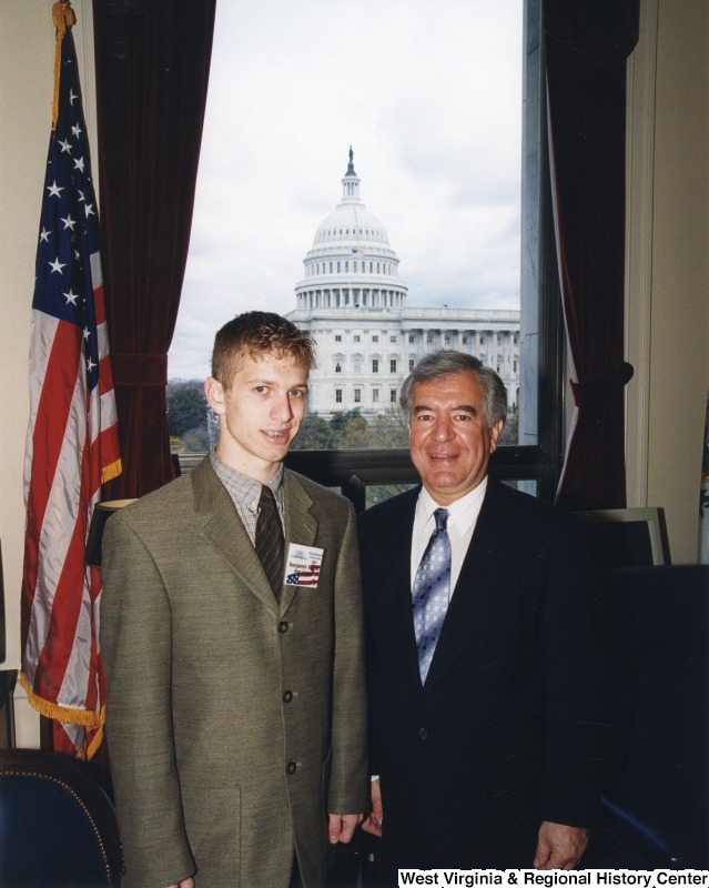 On the right, Representative Nick J. Rahall (D-W.Va.) stands for a photograph in his office with an unidentified man.