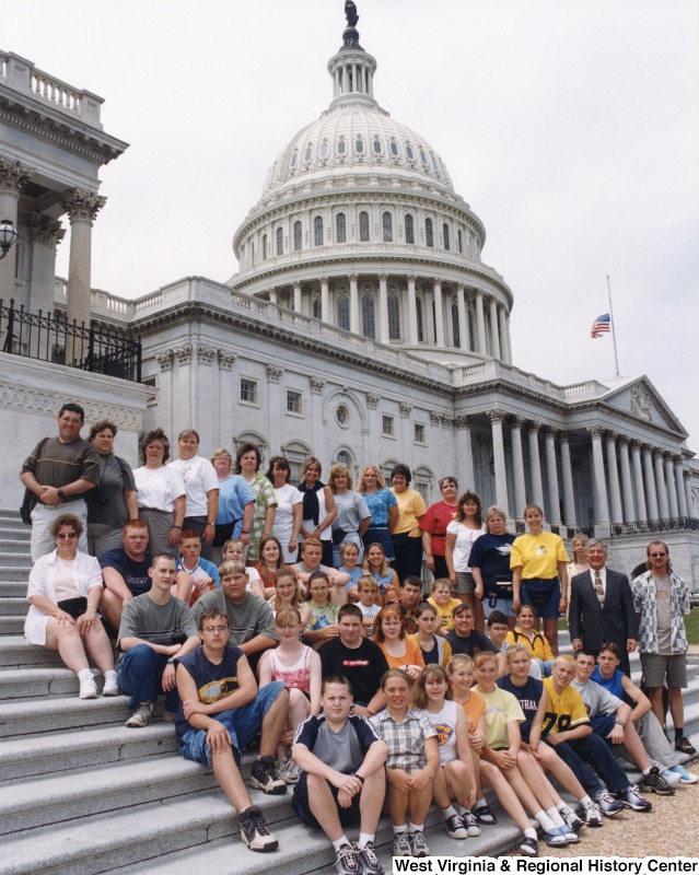 On the right, Representative Nick J. Rahall (D-W.Va.) stands in front of the Capitol building with students from Glade Springs Middle School.