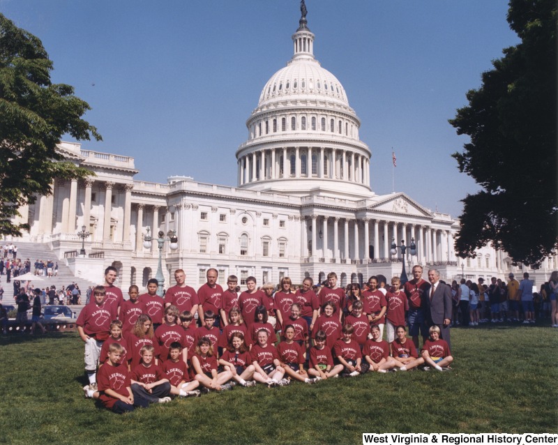 On the far right, Representative Nick J. Rahall (D-W.Va.) stands in front of the Capitol building with students from Alderson Elementary School.