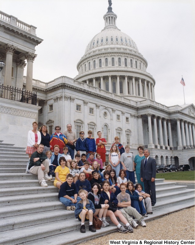 On the far right, Representative Nick J. Rahall (D-W.Va.) stands in front the Capitol building with students from Bramwell Elementary School.