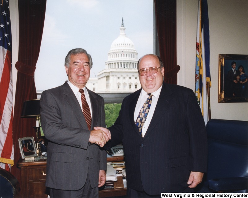 On the left, Representative Nick J. Rahall (D-W.Va.) shakes hands for a photograph with John Reed.