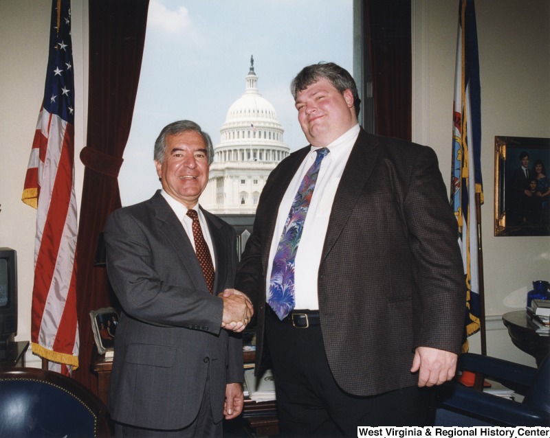 On the left, Representative Nick J. Rahall (D-W.Va.) shakes hands for a photograph with Victor McClure.