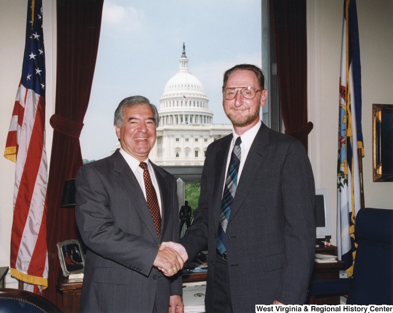 On the left, Representative Nick J. Rahall (D-W.Va.) shakes hands for a photograph with Charles Armentrout.