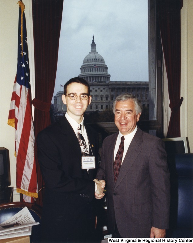 On the right, Representative Nick J. Rahall (D-W.Va.) shaking hands with Matthew Mullens for a picture.