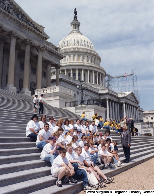 On the far right, Representative Nick J. Rahall (D-W.Va.) stands in front of the Capitol building with a group of school students.